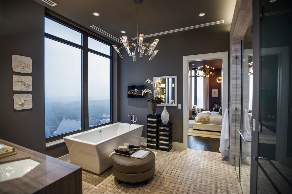 Luxury bathroom renovation with stone tile and glass shower